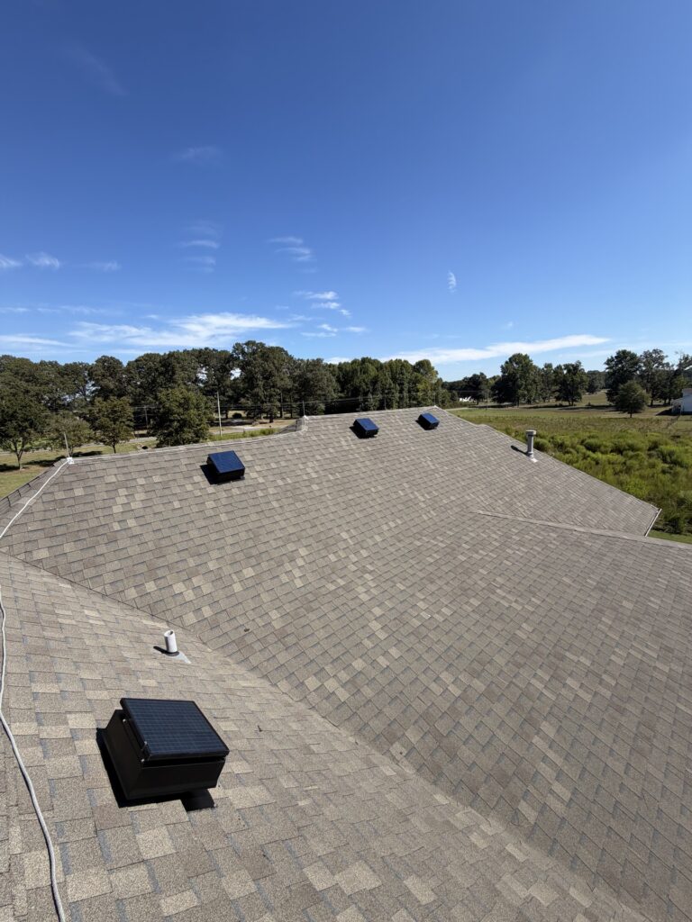 Multiple solar attic fans on a low-slope roof