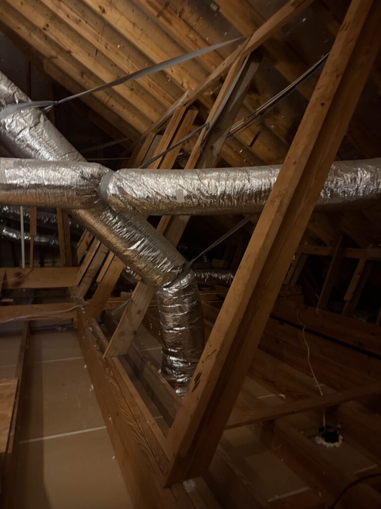 Attic trusses and ducts after cleanout